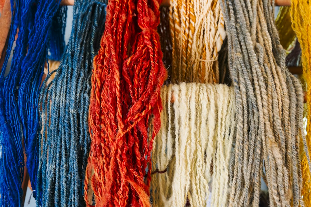 Dyed yarns hanging on a wall